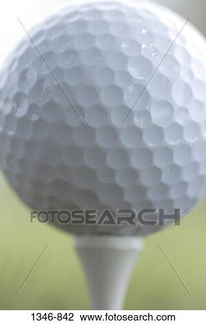 Close-up of a golf ball on a tee View Large Photo Image Stock Image - Close-up of a golf ball on a tee. Fotosearch
