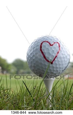 Close-up of a golf ball on a tee with a heart shape drawn on it View Large Photo Image Picture - Close-up of a golf ball on a tee with a heart shape drawn on it. Fotosearch