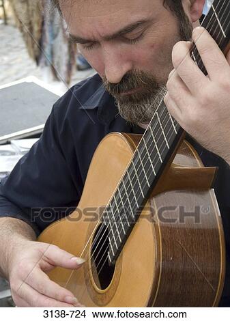 Close-up of a mature man playing a guitar, Buenos Aires, Argentina View Large Photo Image Picture - Close-up of a mature man playing a guitar, Buenos Aires, Argentina. Fotosearch