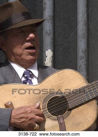 Close-up of a mature man playing a guitar, Buenos Aires, Argentina View Large Photo Image Stock Image - Close-up of a mature man playing a guitar, Buenos Aires, Argentina. Fotosearch