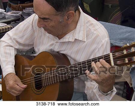 Close-up of a mature man playing a guitar, Buenos Aires, Argentina View Large Photo Image Stock Photo - Close-up of a mature man playing a guitar, Buenos Aires, Argentina. Fotosearch