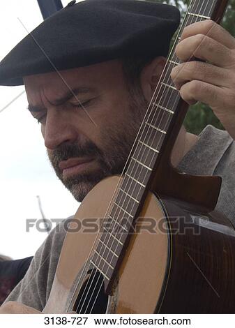 Close-up of a mature man playing a guitar, Buenos Aires, Argentina View Large Photo Image Stock Photo - Close-up of a mature man playing a guitar, Buenos Aires, Argentina. Fotosearch