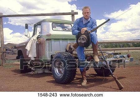 Cowboy holding a rifle, Arizona, USA View Large Photo Image Stock Image - Cowboy holding a rifle, Arizona, USA. Fotosearch
