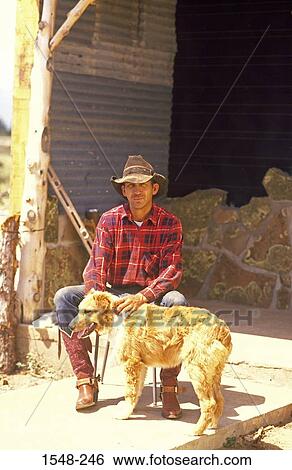 Stock Photograph - Cowboy with a dog. Fotosearch