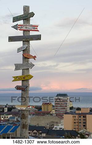 Directional signs on a wooden pole, Punta Arenas, Straight of Magellan, Magellanes, Chile View Large Photo Image Stock Photo - Directional signs on a wooden pole, Punta Arenas, Straight of Magellan, Magellanes, Chile. Fotosearch