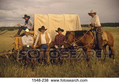 Five cowboys with a covered wagon and a horse on an open range, New Mexico, USA View Large Photo Image Stock Photo - Five cowboys with a covered wagon and a horse on an open range, New Mexico, USA. Fotosearch