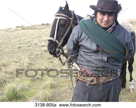 Gaucho standing in a field with his horse, Patagonia, Argentina View Large Photo Image Stock Image - Gaucho standing in a field with his horse, Patagonia, Argentina. Fotosearch
