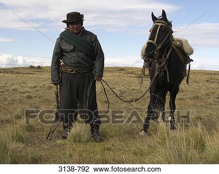 Gaucho standing with a horse, Patagonia, Argentina View Large Photo Image Stock Image - Gaucho standing with a horse, Patagonia, Argentina. Fotosearch