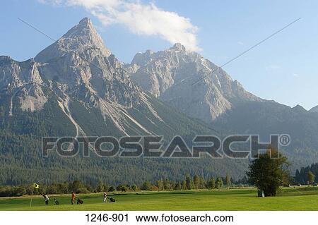 Golf course in front of mountains, Ehrwalder Sonnenspitze and Grunstein Mountains, Tyrol, Austria View Large Photo Image Stock Image - Golf course in front of mountains, Ehrwalder Sonnenspitze and Grunstein Mountains, Tyrol, Austria. Fotosearch
