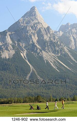 Golf course in front of mountains, Ehrwalder Sonnenspitze and Grunstein Mountains, Tyrol, Austria View Large Photo Image Stock Image - Golf course in front of mountains, Ehrwalder Sonnenspitze and Grunstein Mountains, Tyrol, Austria. Fotosearch