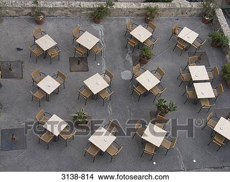 Picture - High angle view of empty tables and chairs in a restaurant, Malta. Fotosearch