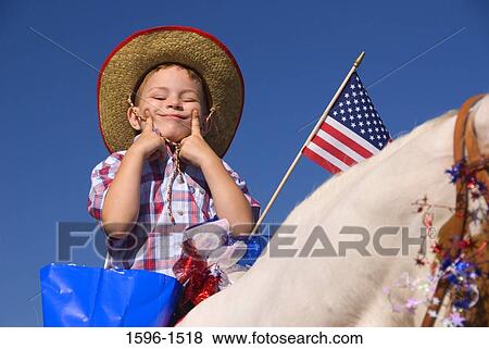Low angle view of a boy riding a horse and making a funny face, St. Paul Rodeo Parade, St. Paul, Marion County, Oregon, USA View Large Photo Image Stock Photo - Low angle view of a boy riding a horse and making a funny face, St. Paul Rodeo Parade, St. Paul, Marion County, Oregon, USA. Fotosearch
