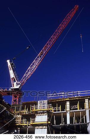 Stock Photograph - Low angle view of a crane at a construction site, New York City, New York State, USA. Fotosearch