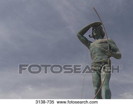 Stock Photography - Low angle view of a statue of a Tehuelche Indian tribal man, Puerto Madryn, Chubut, Patagonia, Argentina. Fotosearch