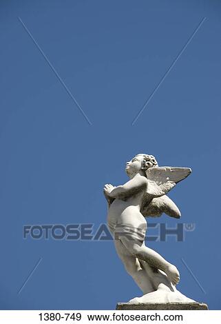 Low angle view of a statue of an angel, Recoleta Cemetery, Buenos Aires, Argentina View Large Photo Image Stock Photo - Low angle view of a statue of an angel, Recoleta Cemetery, Buenos Aires, Argentina. Fotosearch