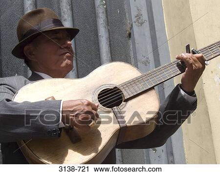 Mature man playing a guitar, Buenos Aires, Argentina View Large Photo Image Stock Image - Mature man playing a guitar, Buenos Aires, Argentina. Fotosearch