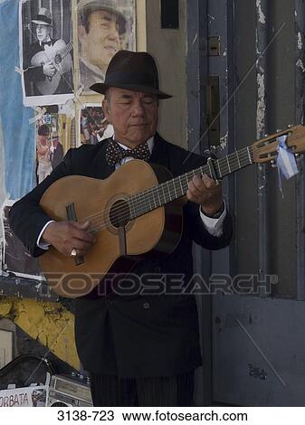Mature man playing a guitar, Buenos Aires, Argentina View Large Photo Image Stock Image - Mature man playing a guitar, Buenos Aires, Argentina. Fotosearch