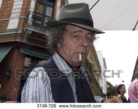 Mature man smoking a cigarette, Buenos Aires, Argentina View Large Photo Image Stock Photograph - Mature man smoking a cigarette, Buenos Aires, Argentina. Fotosearch