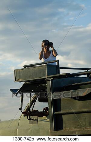 Mid adult woman using binoculars for bird watching, Hato Pinero, Llanos, Venezuela View Large Photo Image Stock Image - Mid adult woman using binoculars for bird watching, Hato Pinero, Llanos, Venezuela. Fotosearch