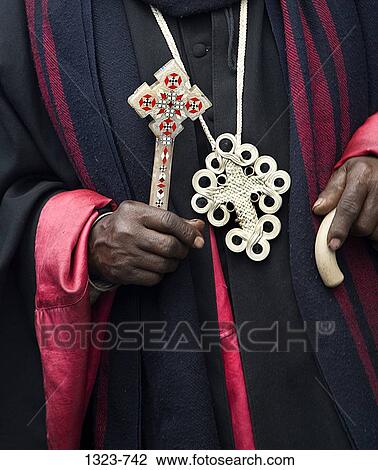 Mid section view of a priest holding a cross, Ethiopian Orthodox church, Timkat Festival, Addis Ababa, Ethiopia View Large Photo Image Stock Image - Mid section view of a priest holding a cross, Ethiopian Orthodox church, Timkat Festival, Addis Ababa, Ethiopia. Fotosearch