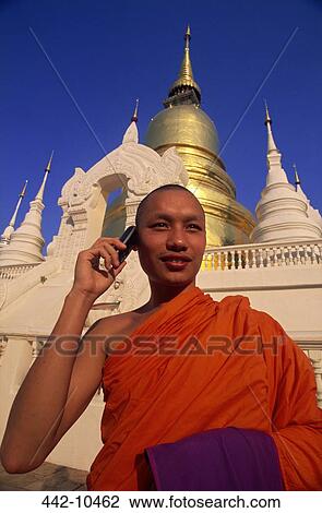 Monk talking on a mobile phone in front of a temple, Chiang Mai, Chiang Mai Province, Thailand View Large Photo Image Stock Image - Monk talking on a mobile phone in front of a temple, Chiang Mai, Chiang Mai Province, Thailand. Fotosearch