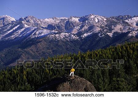 Person standing on a rock, Stuart Range, Red Top Lookout, Wenatchee National Forest, Washington State, USA View Large Photo Image Stock Image - Person standing on a rock, Stuart Range, Red Top Lookout, Wenatchee National Forest, Washington State, USA. Fotosearch