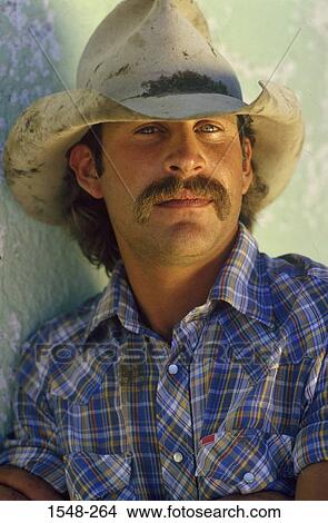 Portrait of a cowboy leaning against a wall View Large Photo Image Picture - Portrait of a cowboy leaning against a wall. Fotosearch
