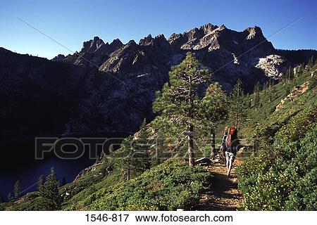 Rear view of a man hiking on mountains, Sierra Buttes, Sierra County, California, USA View Large Photo Image Stock Photo - Rear view of a man hiking on mountains, Sierra Buttes, Sierra County, California, USA. Fotosearch