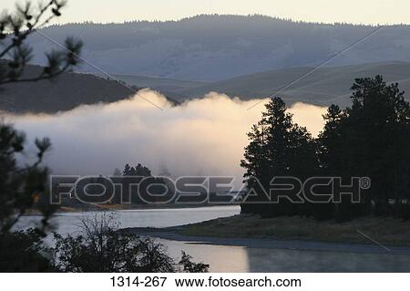 River flowing through mountains, Flathead River, Montana, USA View Large Photo Image Stock Photo - River flowing through mountains, Flathead River, Montana, USA. Fotosearch