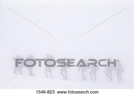 Stock Image - Side profile of a group of mountaineers climbing a mountain, Mt Rainier, Washington State, USA. Fotosearch