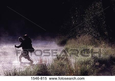 Stock Photography - Side profile of a man walking through a river, Truckee River, California, USA. Fotosearch
