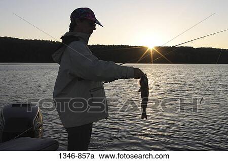 Woman holding a bass View Large Photo Image Stock Image - Woman holding a bass. Fotosearch
