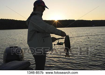 Woman holding a bass View Large Photo Image Stock Image - Woman holding a bass. Fotosearch