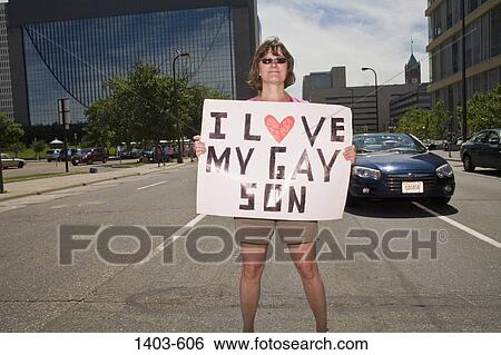 Woman holding a placard in a gay pride parade, Minneapolis, Minnesota, USA View Large Photo Image Stock Photograph - Woman holding a placard in a gay pride parade, Minneapolis, Minnesota, USA. Fotosearch