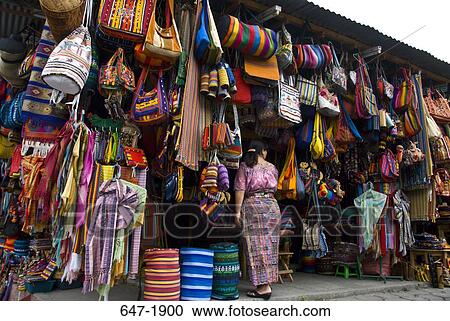 Stock Image - Woman standing in front of a store, Chichicastenango, Guatemala. Fotosearch