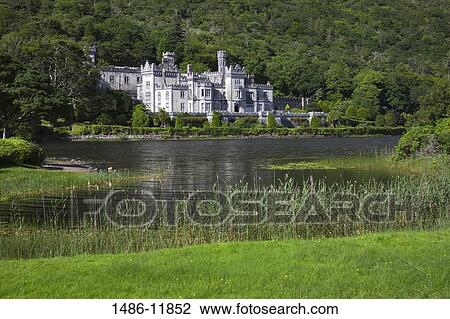 Stock Image - Abbey at the lakeside, Kylemore Abbey, Lake Kylemore, Connemara, County Galway, Connacht Province, Republic of Ireland. Fotosearch