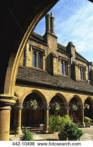 Almshouse viewed from an arch, St. John's Almshouse, Sherborne, Somerset, Dorset, England View Large Photo Image Stock Photo - Almshouse viewed from an arch, St. John's Almshouse, Sherborne, Somerset, Dorset, England. Fotosearch