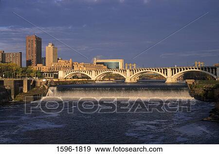Stock Photo - Arch bridge across a river, St. Anthony Falls, Stone Arch Bridge, Minneapolis, Hennepin County, Minnesota, USA. Fotosearch