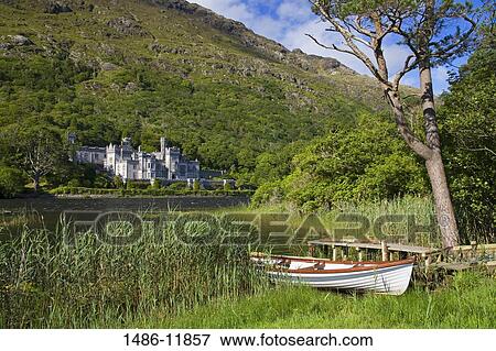 Boat at the lakeside with an abbey in the background, Kylemore Abbey, Lake Kylemore, Connemara, County Galway, Connacht Province, Republic of Ireland View Large Photo Image Stock Photo - Boat at the lakeside with an abbey in the background, Kylemore Abbey, Lake Kylemore, Connemara, County Galway, Connacht Province, Republic of Ireland. Fotosearch