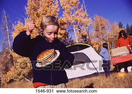 Boy holding a plate of breads and a fork while camping, Truckee, Nevada County, California, USA View Large Photo Image Stock Image - Boy holding a plate of breads and a fork while camping, Truckee, Nevada County, California, USA. Fotosearch
