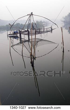 Chinese fishing net in a lagoon, Kerala Backwaters, Cherai, Ernakulam District, Kerala, India View Large Photo Image Stock Photo - Chinese fishing net in a lagoon, Kerala Backwaters, Cherai, Ernakulam District, Kerala, India. Fotosearch