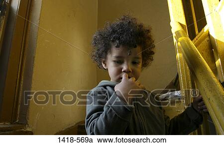 Close-up of a boy on a staircase View Large Photo Image Stock Image - Close-up of a boy on a staircase. Fotosearch