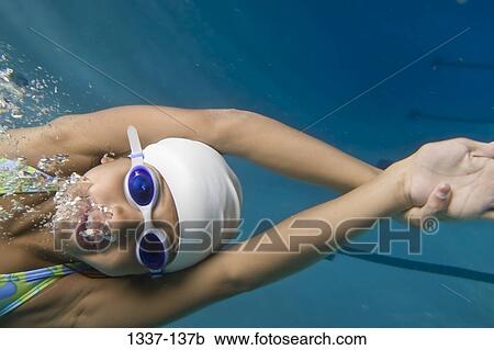 Close-up of a girl swimming in a swimming pool View Large Photo Image Stock Image - Close-up of a girl swimming in a swimming pool. Fotosearch