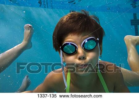 Close-up of a girl swimming in a swimming pool View Large Photo Image Stock Photography - Close-up of a girl swimming in a swimming pool. Fotosearch