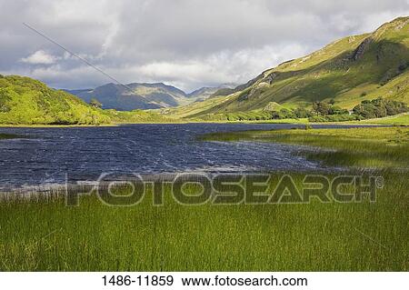 Stock Photo - Clouds over a lake and mountains, Lake Kylemore, Connemara, County Galway, Connacht Province, Republic of Ireland. Fotosearch