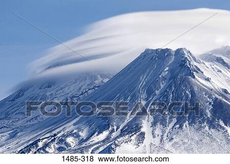 Stock Photo - Clouds over a snow covered mountain, Mt Shasta, Siskiyou County, California, USA. Fotosearch