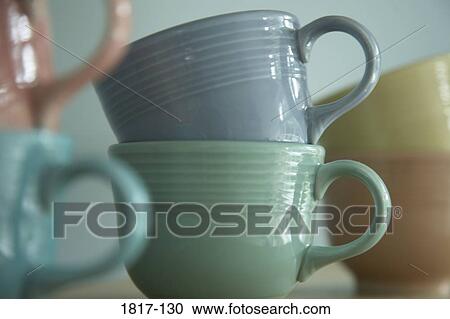 Colorful tea cups stacked on a kitchen shelf View Large Photo Image Stock Image - Colorful tea cups stacked on a kitchen shelf. Fotosearch