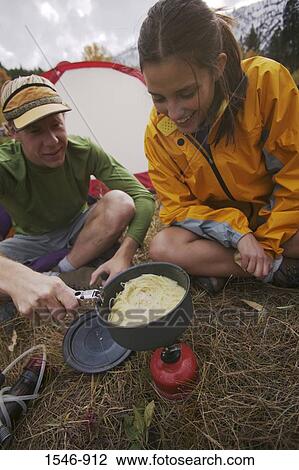 Couple cooking food while camping, Truckee River, California, USA View Large Photo Image Stock Image - Couple cooking food while camping, Truckee River, California, USA. Fotosearch