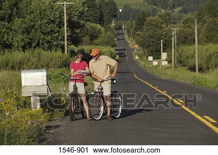 Couple reading mails by a mailbox while riding bicycles, Parkdale, Hood River County, Oregon, USA View Large Photo Image Stock Image - Couple reading mails by a mailbox while riding bicycles, Parkdale, Hood River County, Oregon, USA. Fotosearch