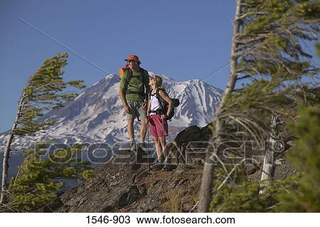 Stock Image - Couple standing on a mountain summit, Mt Adams, Washington State, USA. Fotosearch